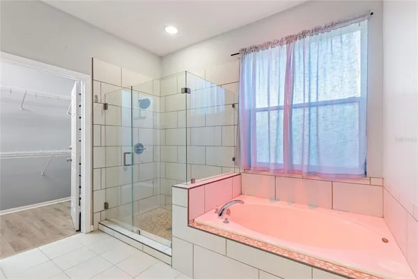 a bathroom with a tub and shower