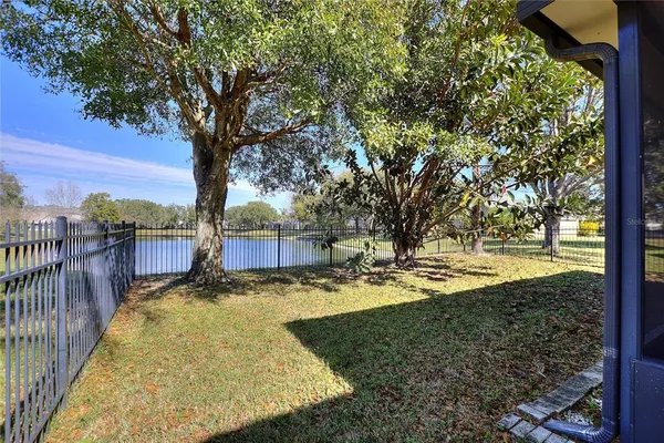 a view of a yard with wooden fence