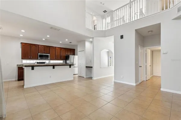 a view of kitchen with stainless steel appliances granite countertop a refrigerator and a sink