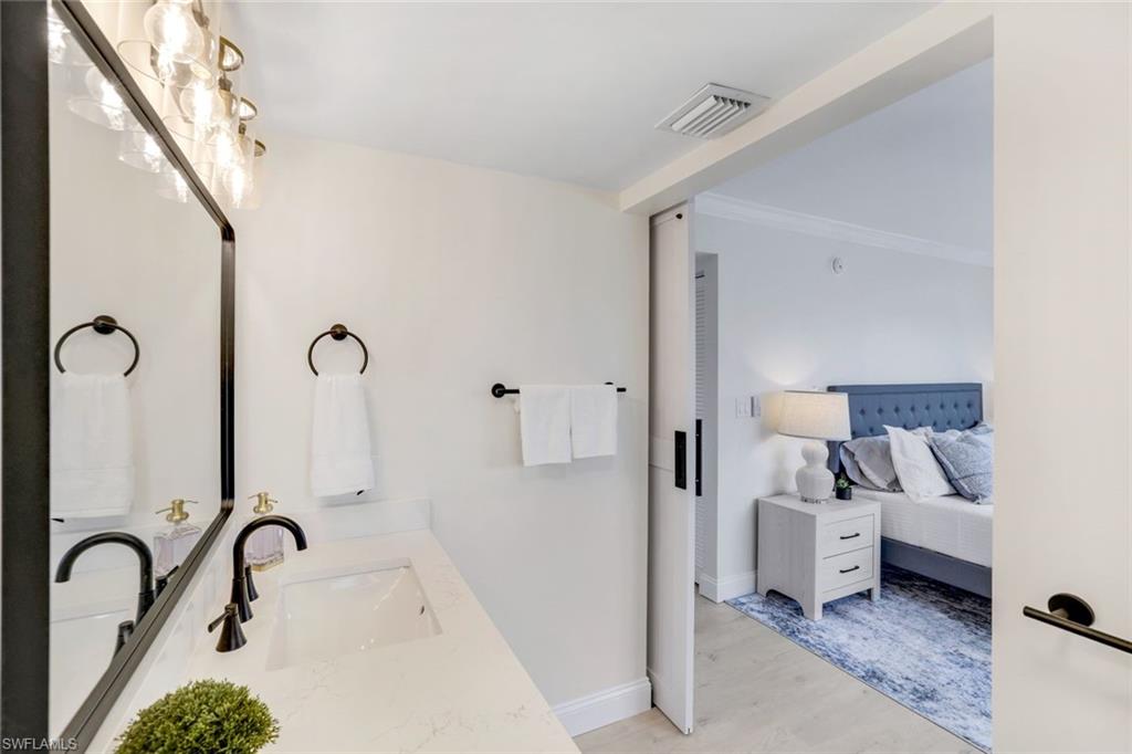 4150 Crayton Road, Unit B2 Naples, FL 34103 - Photo 11 of 23 a bathroom with a tub sink and mirror