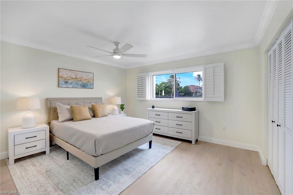 4150 Crayton Road, Unit B2 Naples, FL 34103 - Photo 13 of 23 a bedroom with a bed and a dresser