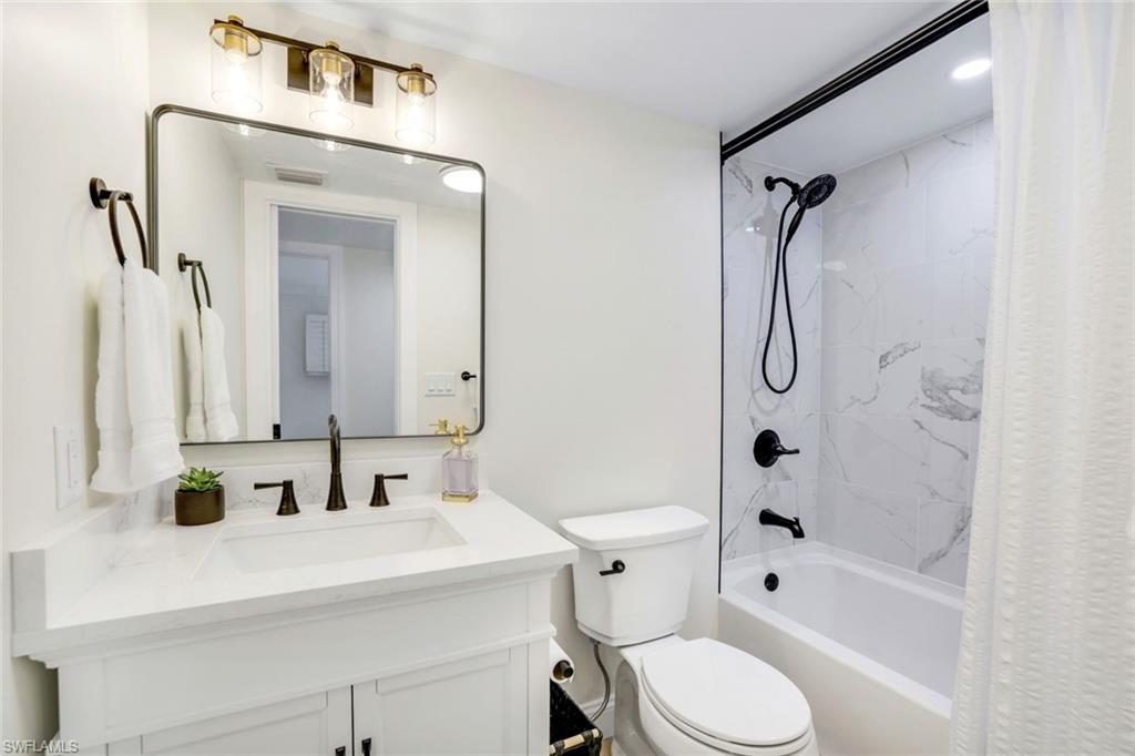 4150 Crayton Road, Unit B2 Naples, FL 34103 - Photo 14 of 23 a bathroom with a sink toilet and shower