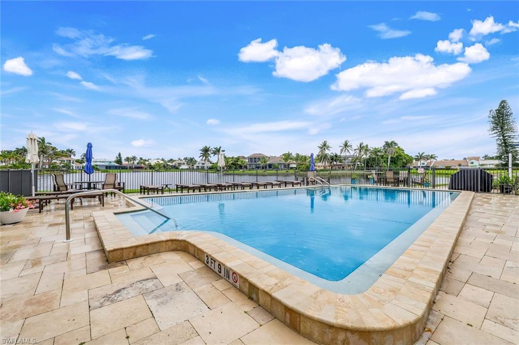4150 Crayton Road, Unit B2 Naples, FL 34103 - Photo 17 of 23 a view of a swimming pool with lounge chair