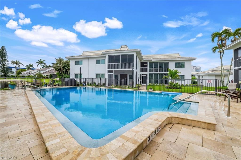 4150 Crayton Road, Unit B2 Naples, FL 34103 - Photo 18 of 23 a swimming pool with outdoor seating and yard