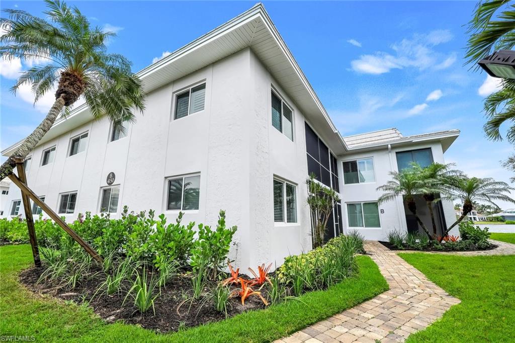 4150 Crayton Road, Unit B2 Naples, FL 34103 - Photo 20 of 23 a front view of a house with a yard