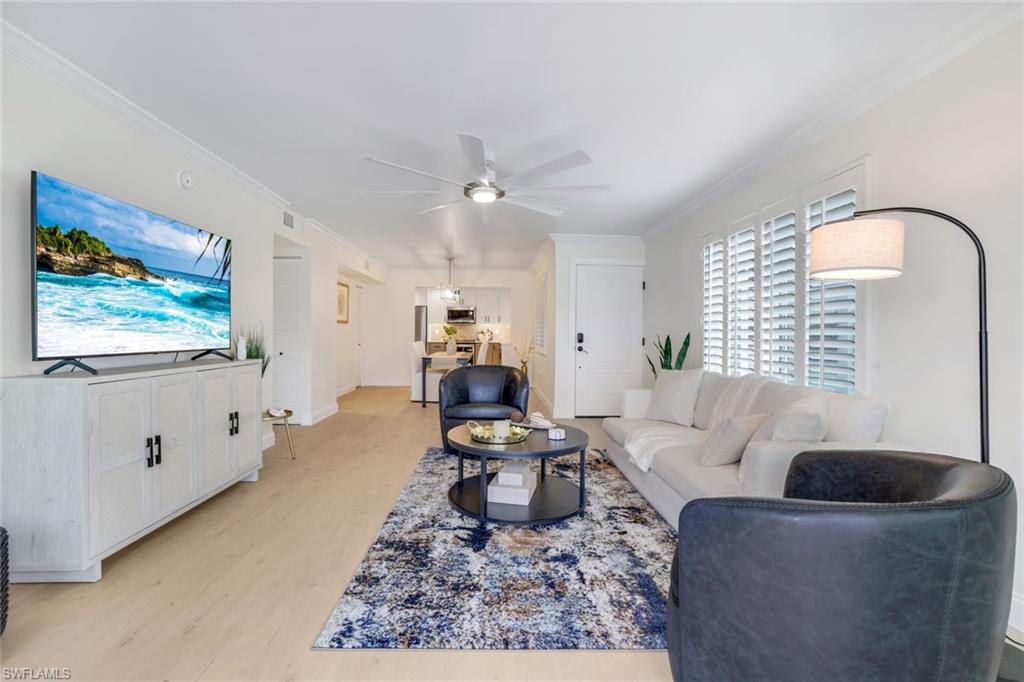 4150 Crayton Road, Unit B2 Naples, FL 34103 - Photo 3 of 23 a living room with furniture and a large window