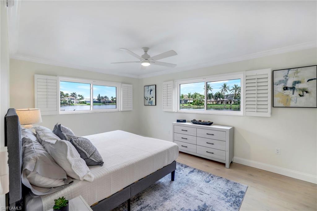 4150 Crayton Road, Unit B2 Naples, FL 34103 - Photo 9 of 23 a bedroom with a bed and a dresser