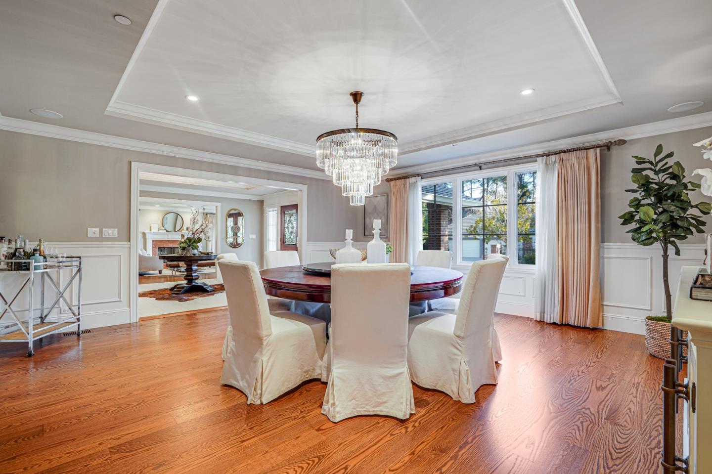15 Joyce Road Hillsborough, CA 94010 - Photo 12 of 70 a dining room with wooden floor a chandelier a glass table and chairs
