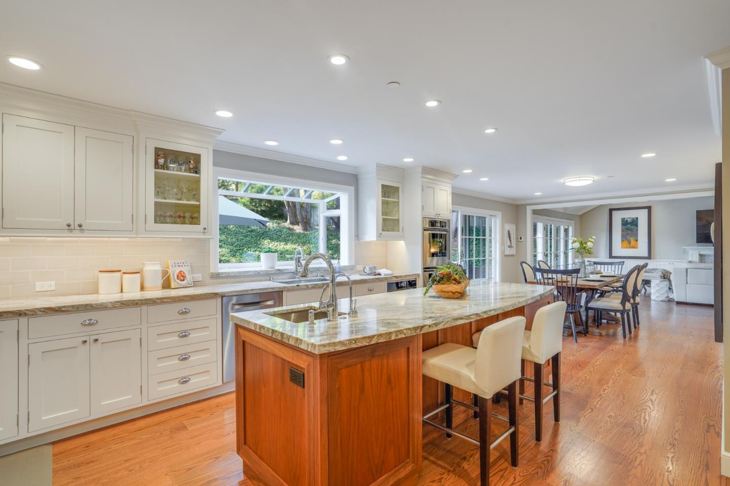 15 Joyce Road Hillsborough, CA 94010 - Photo 16 of 70 a kitchen with granite countertop a stove a sink a dining table and chairs