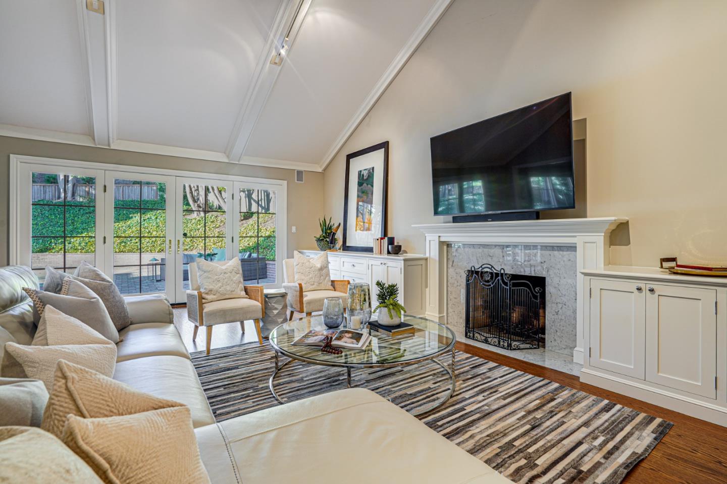 15 Joyce Road Hillsborough, CA 94010 - Photo 28 of 70 a living room with furniture a flat screen tv and a fireplace