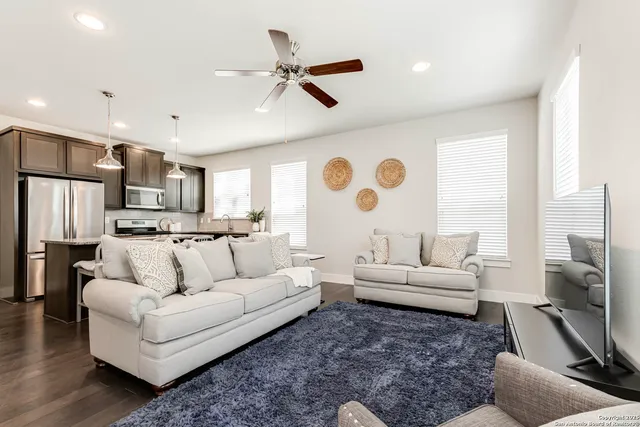 a living room with furniture and a large window