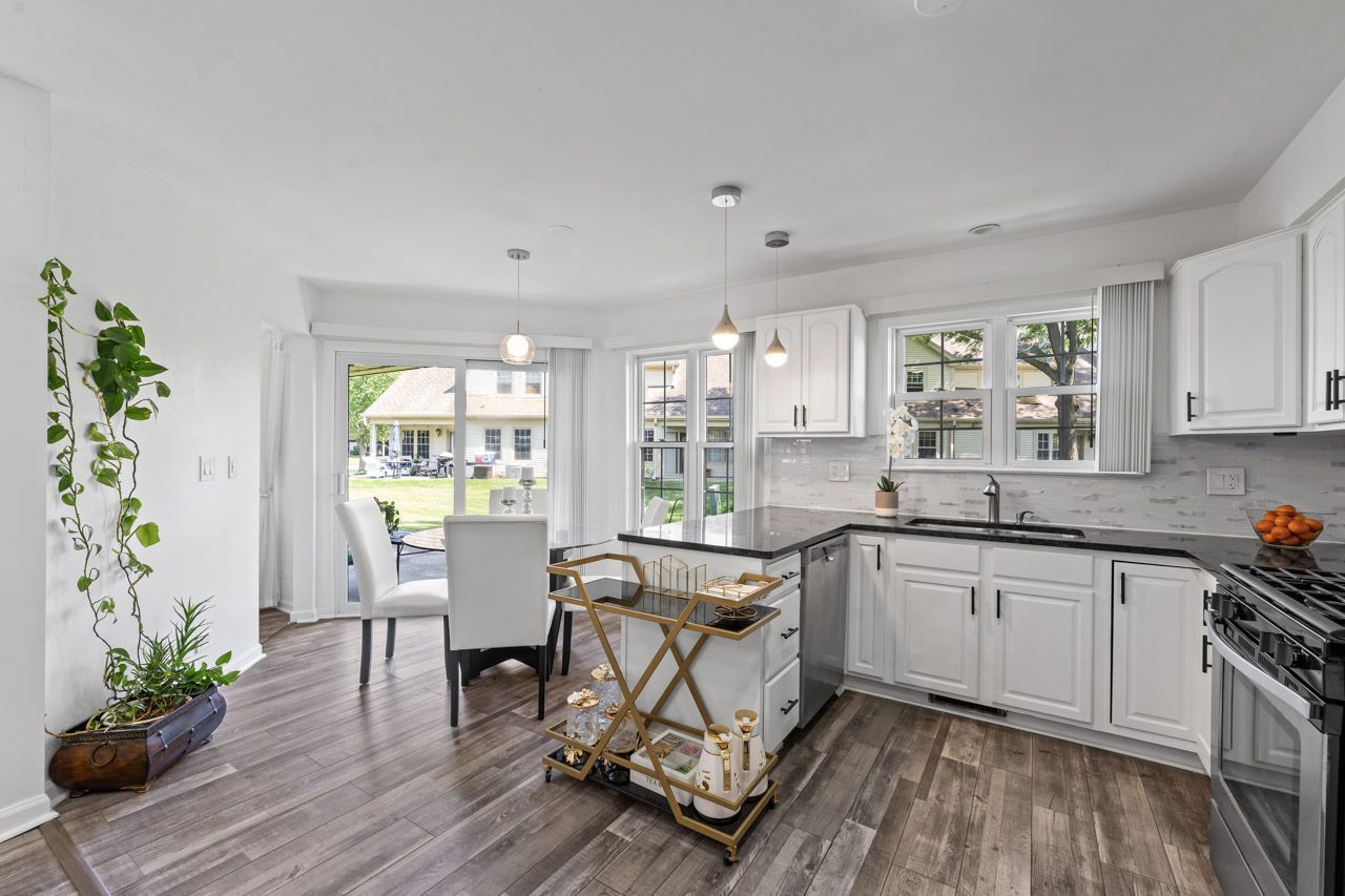 706 Brandon Place Wheeling, IL 60090 - Photo 20 of 42 a view of a kitchen with dining table chairs and wooden floor
