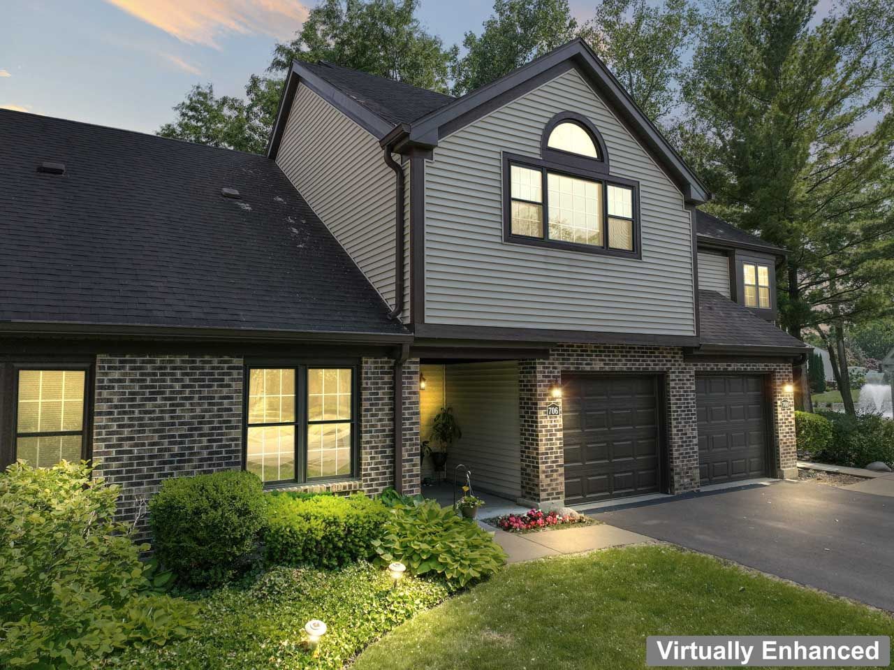 706 Brandon Place Wheeling, IL 60090 - Photo 2 of 42 a front view of a house with a yard and garage