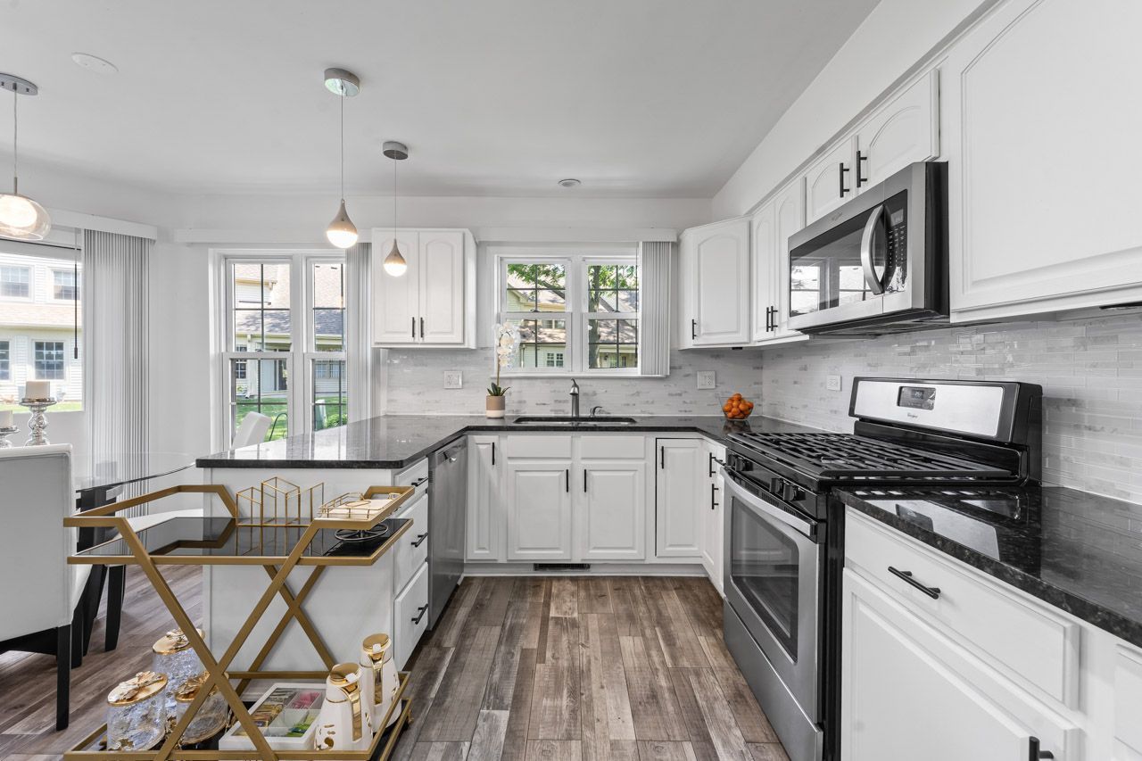 706 Brandon Place Wheeling, IL 60090 - Photo 21 of 42 a kitchen with a stove a sink and a microwave