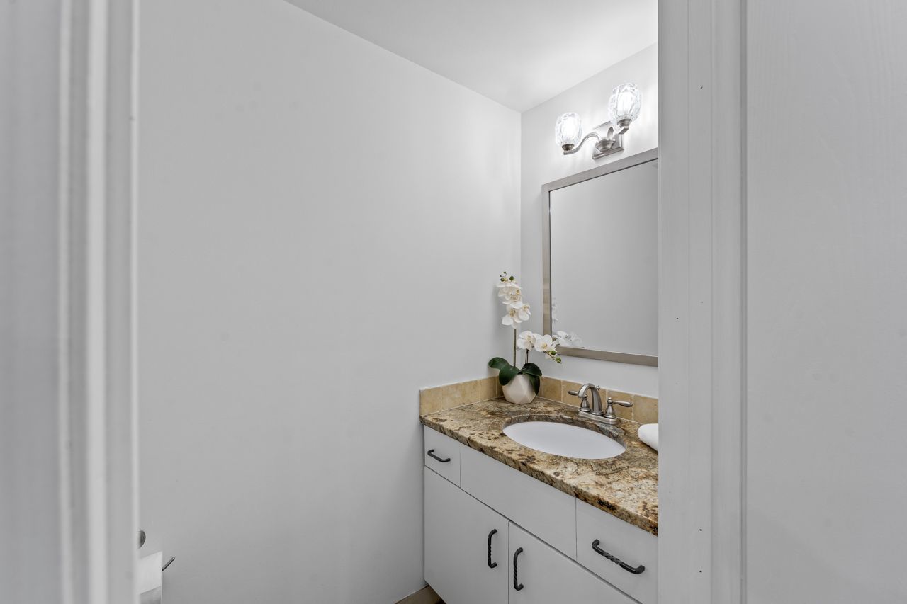 706 Brandon Place Wheeling, IL 60090 - Photo 25 of 42 a bathroom with a granite countertop sink and a mirror