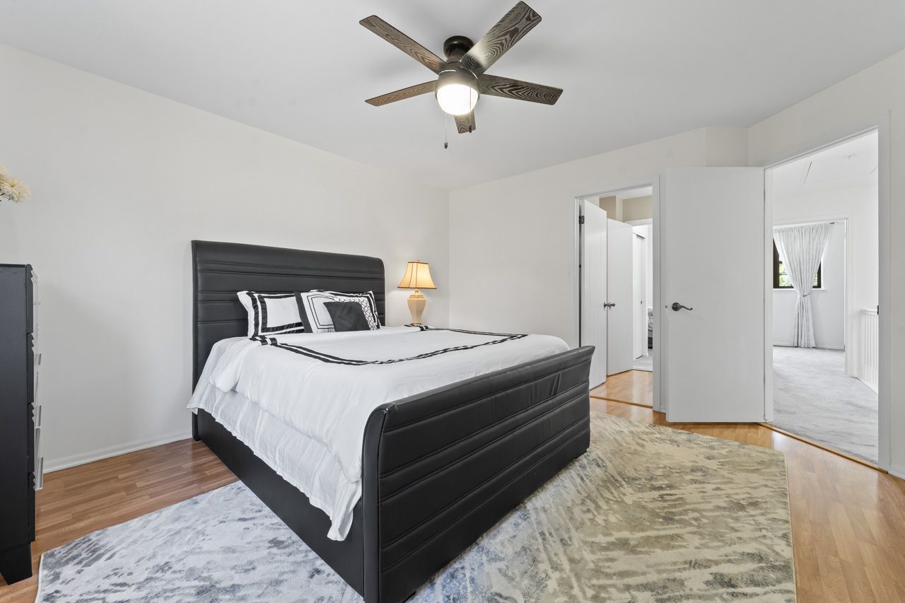 706 Brandon Place Wheeling, IL 60090 - Photo 27 of 42 a bedroom with a bed and a ceiling fan