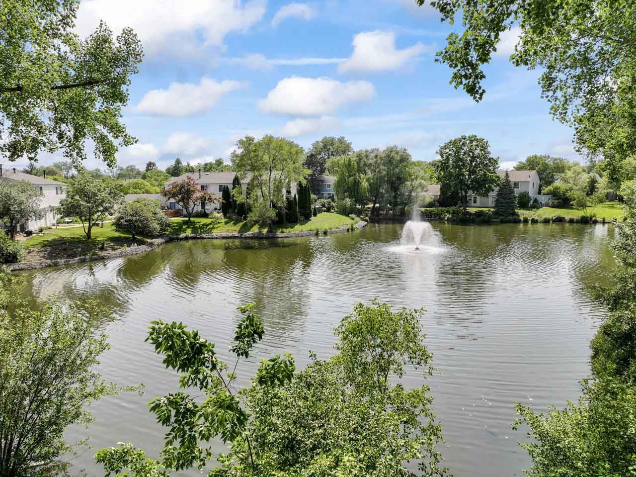 706 Brandon Place Wheeling, IL 60090 - Photo 40 of 42 a view of a lake with houses in the back