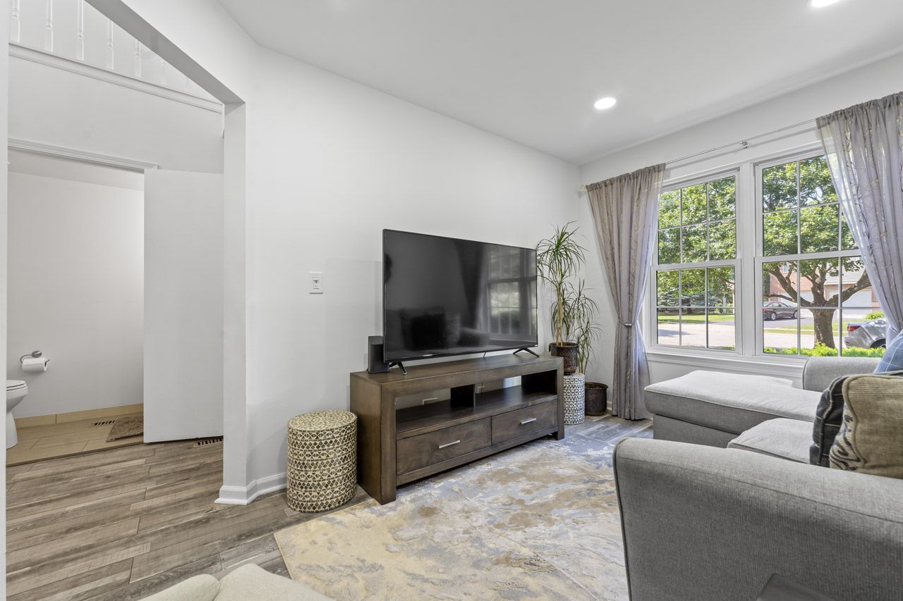 706 Brandon Place Wheeling, IL 60090 - Photo 6 of 42 a living room with furniture and a flat screen tv