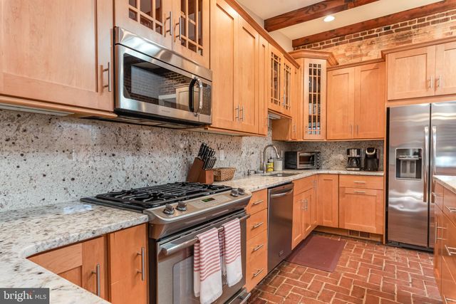 a living room with a fireplace and a flat screen tv