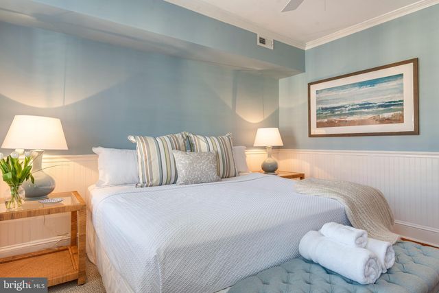 a bedroom with bed and a couch