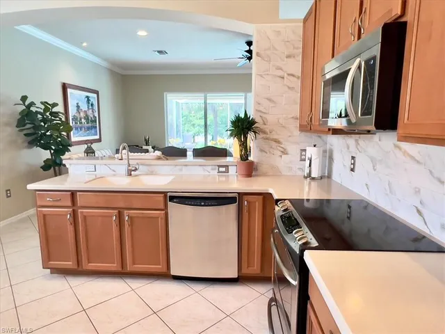 a kitchen with stainless steel appliances a sink stove and cabinets