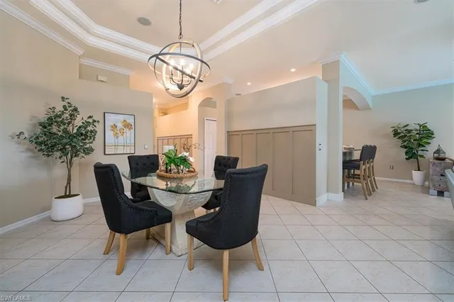 a dining room with furniture and a chandelier