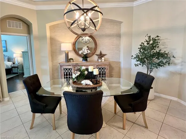 a view of a dining room with furniture and chandelier