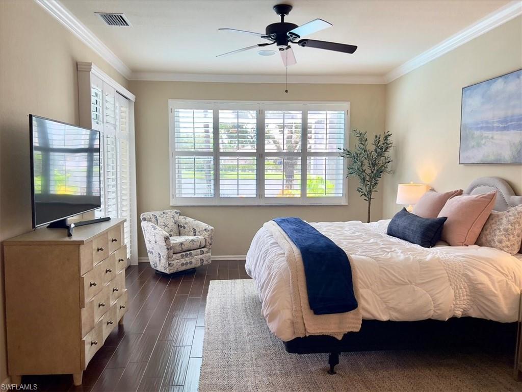 14291 Manchester Drive Naples, FL 34114 - Photo 23 of 49 a bedroom with a bed and a flat screen tv