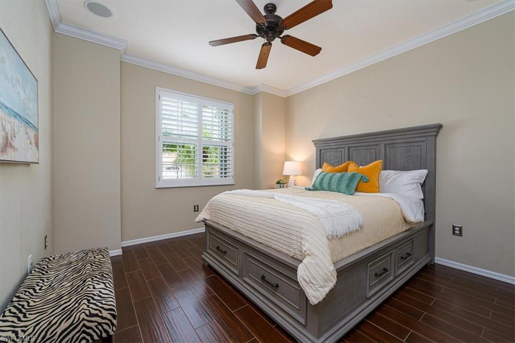 14291 Manchester Drive Naples, FL 34114 - Photo 28 of 49 a bed sitting in a bedroom next to a window