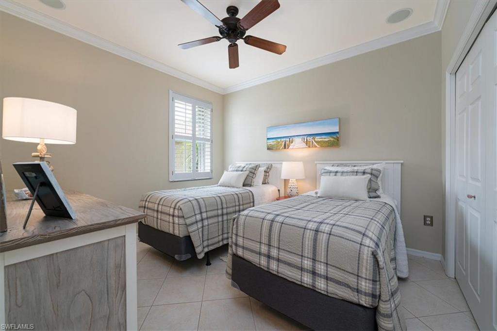 14291 Manchester Drive Naples, FL 34114 - Photo 30 of 49 a bedroom with a bed a couch and a window