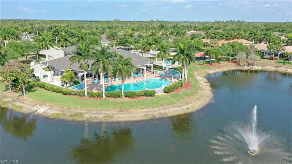 14291 Manchester Drive Naples, FL 34114 - Photo 3 of 49 a view of a lake with a yard and mountain in the back