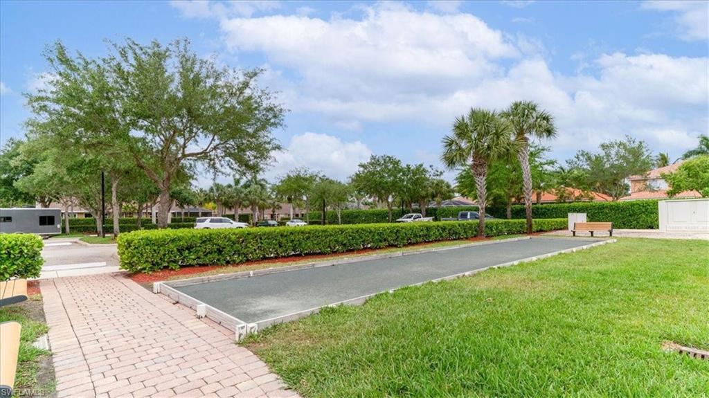 14291 Manchester Drive Naples, FL 34114 - Photo 44 of 49 a view of a street with a houses in the background
