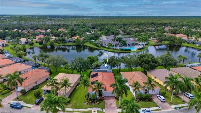 an aerial view of residential house with outdoor space and lake view in back