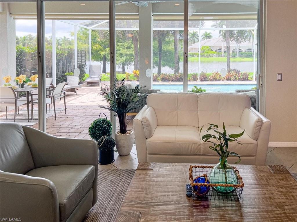 14291 Manchester Drive Naples, FL 34114 - Photo 9 of 49 a living room with furniture and a wooden floor