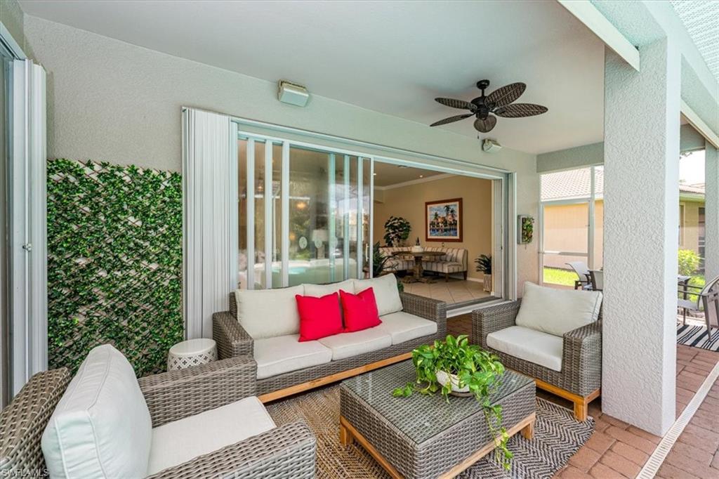 14291 Manchester Drive Naples, FL 34114 - Photo 10 of 49 a living room with furniture and a potted plant