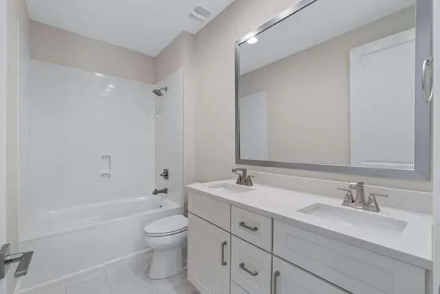 a bathroom with a toilet a sink and bathtub