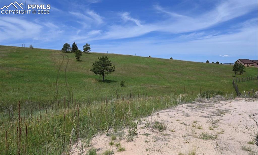 16635 Dancing Wolf Way Colorado Springs, CO 80908 - Photo 17 of 29 a view of a lake with a big yard