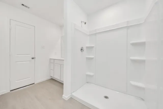 a bathroom with a shower and tub