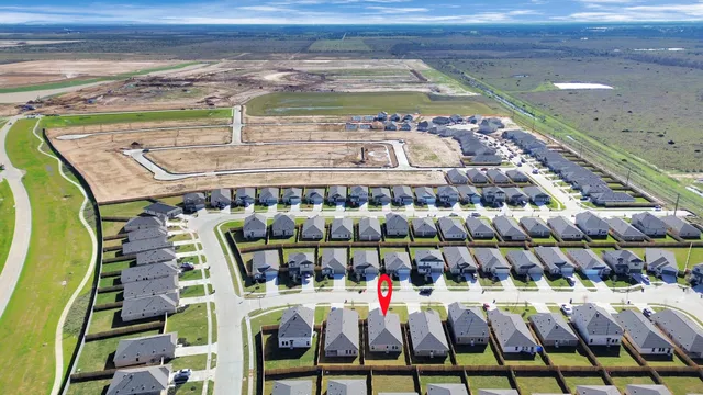 an aerial view of residential houses with street