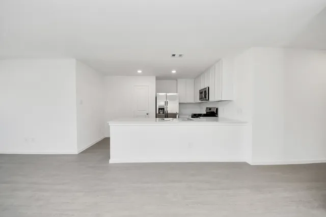 a view of kitchen with stainless steel appliances cabinets