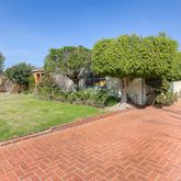 a sidewalk with a building in the background