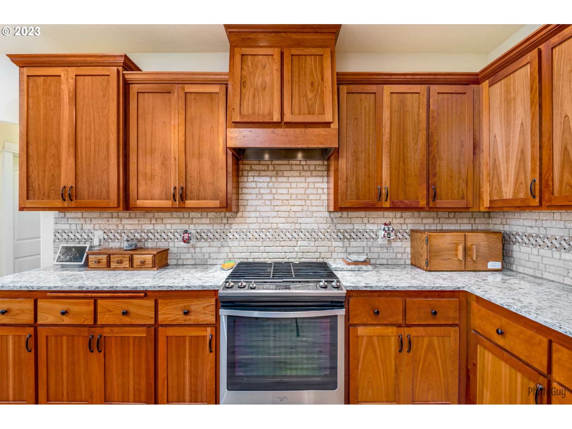 975 Riverstone Lane Springfield, OR 97477 - Photo 12 of 27 a kitchen with granite countertop stainless steel appliances a sink dishwasher stove and cabinets