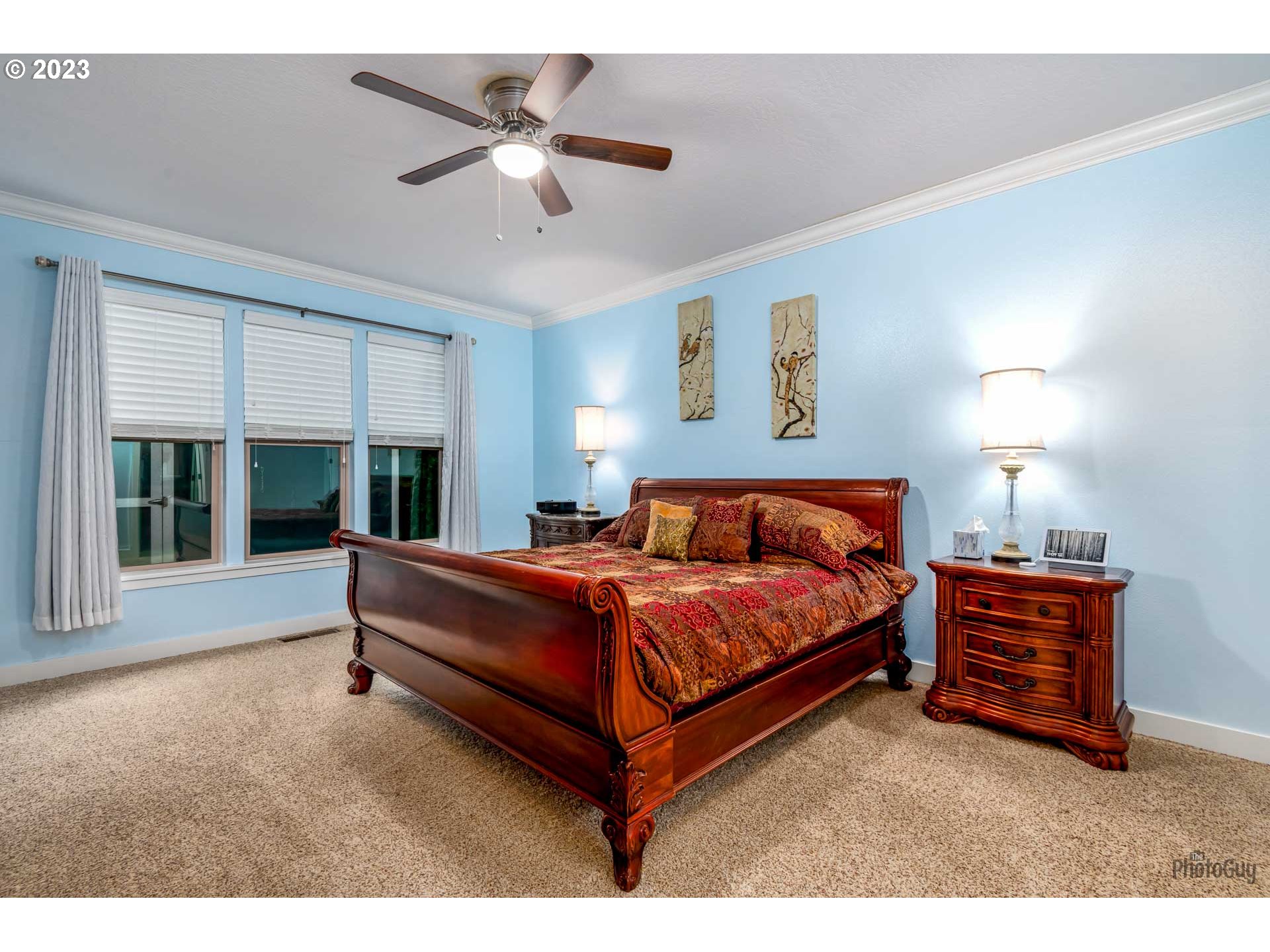 975 Riverstone Lane Springfield, OR 97477 - Photo 15 of 27 a spacious bedroom with a bed and a large window
