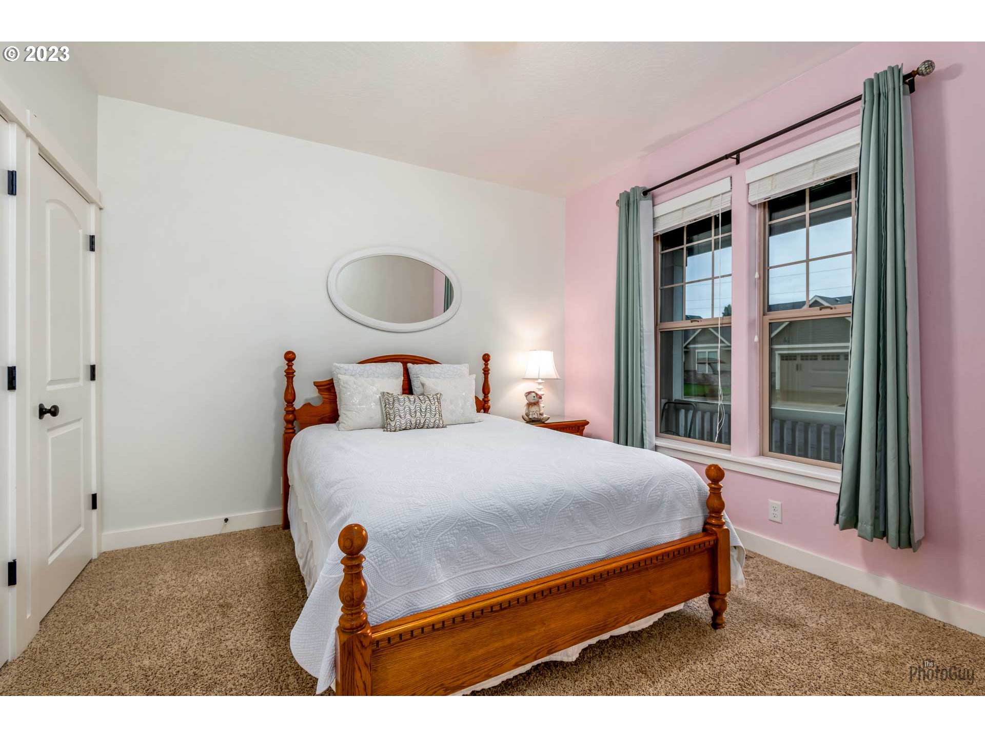 975 Riverstone Lane Springfield, OR 97477 - Photo 17 of 27 a bedroom with a bed and a large window