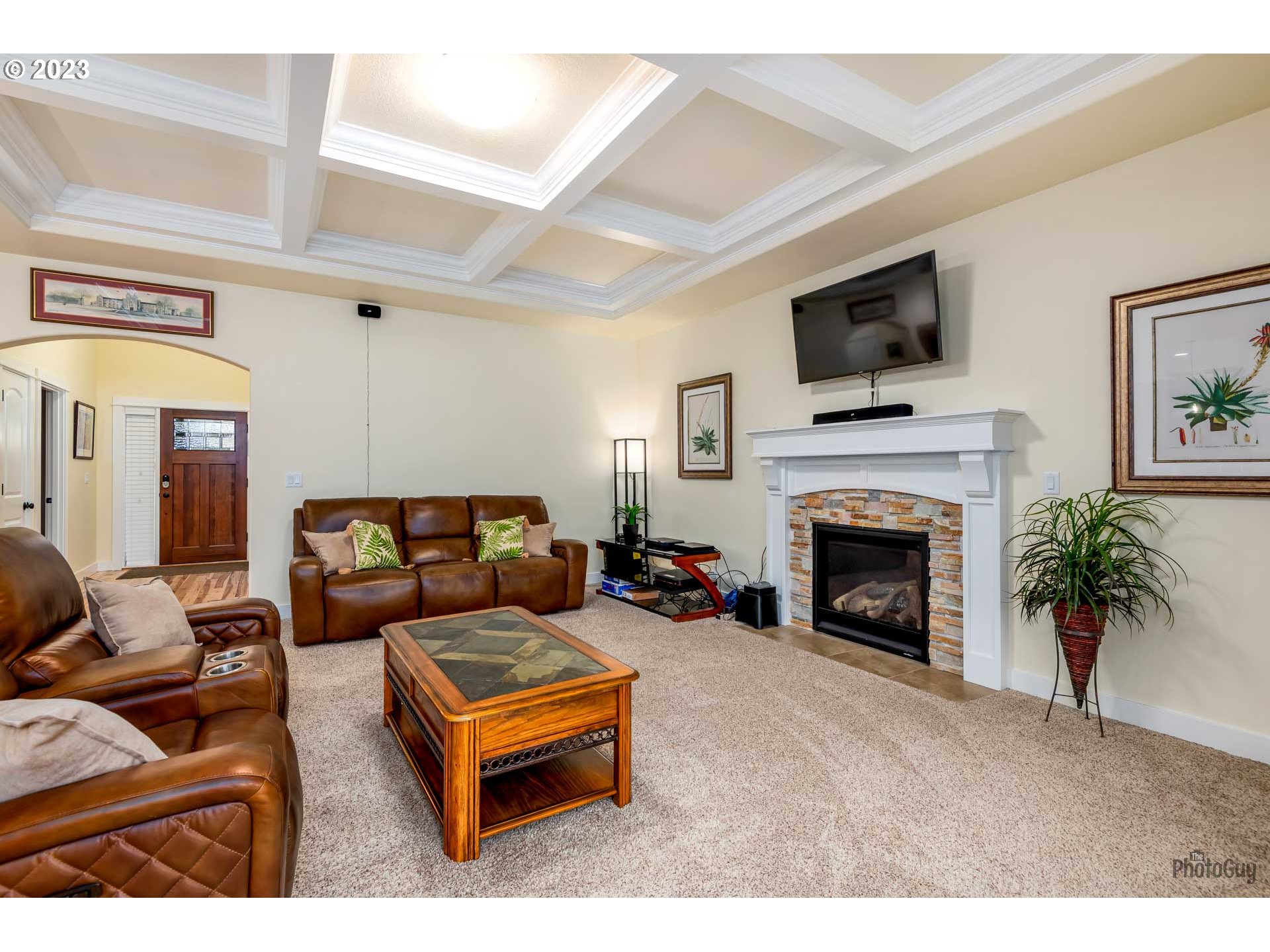 975 Riverstone Lane Springfield, OR 97477 - Photo 5 of 27 a living room with furniture a flat screen tv and a fireplace