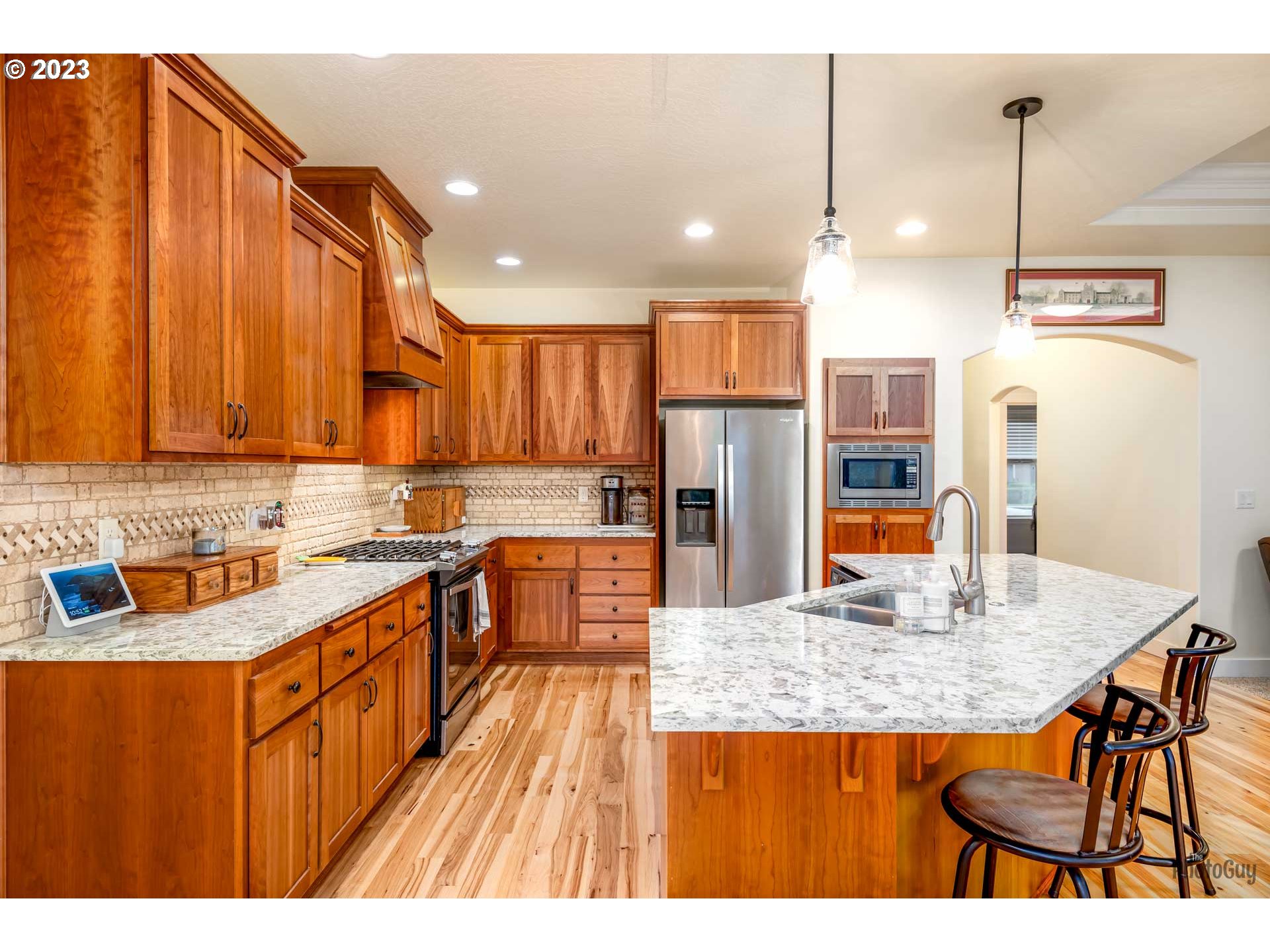 975 Riverstone Lane Springfield, OR 97477 - Photo 10 of 27 a kitchen with stainless steel appliances granite countertop a sink a stove top oven a counter space and cabinets
