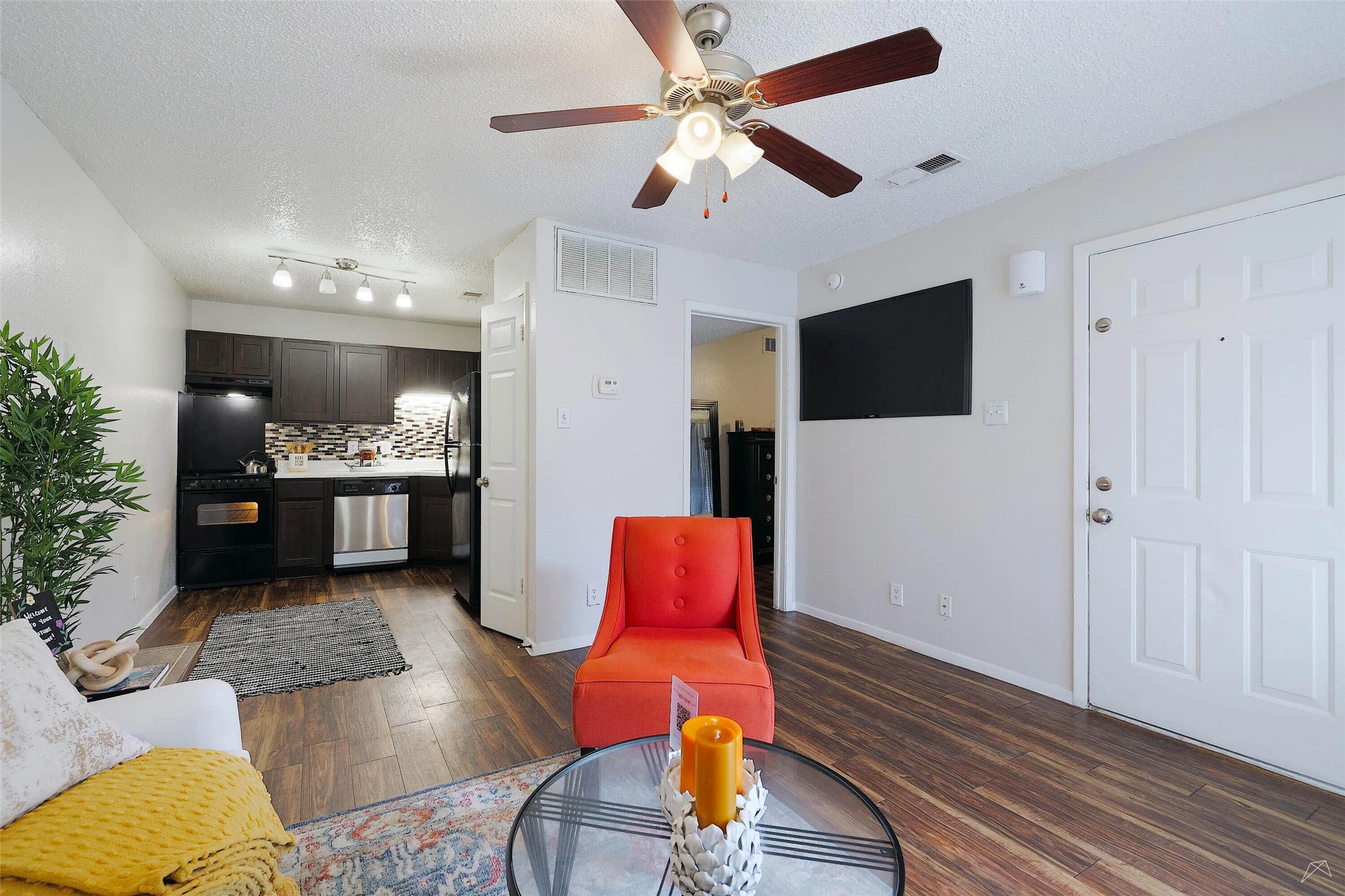 6808 South I-35 Frontage Road, Unit 111 Austin, TX 78745 - Photo 13 of 22 a living room with furniture and a flat screen tv
