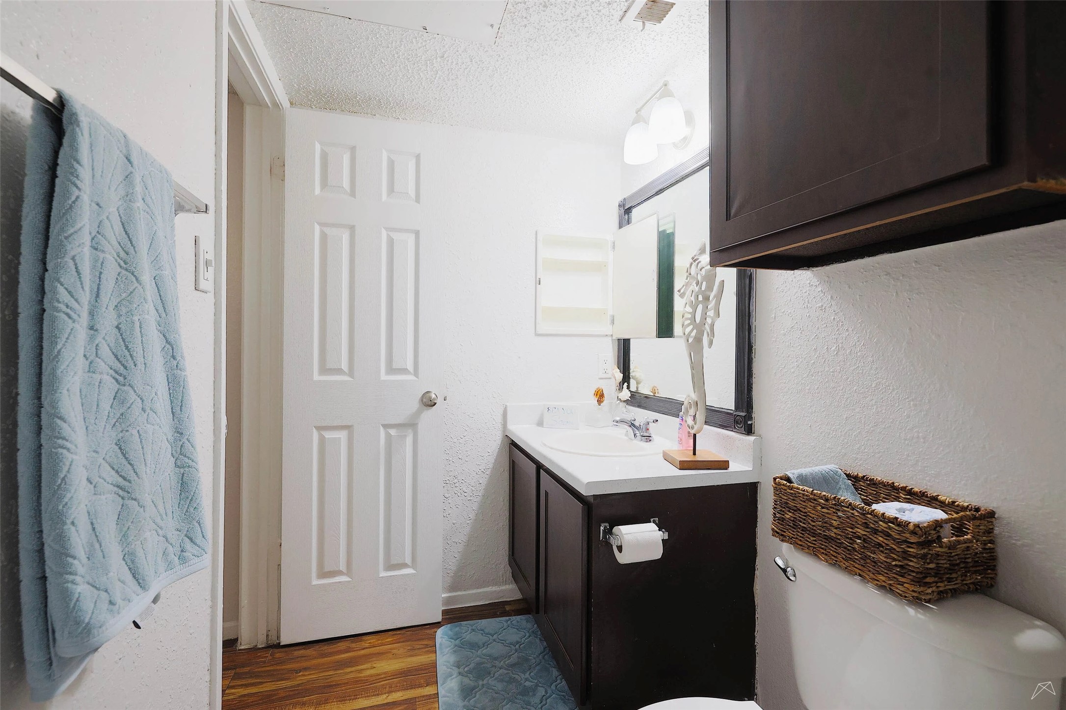 6808 South I-35 Frontage Road, Unit 111 Austin, TX 78745 - Photo 15 of 22 a bathroom with a sink a toilet and mirror