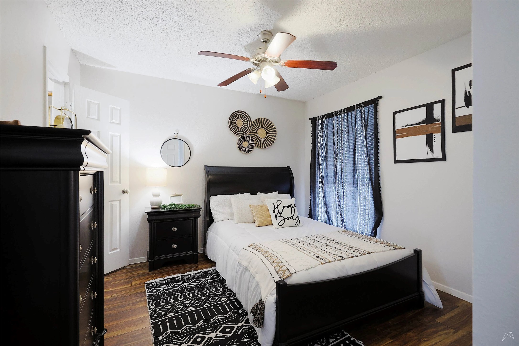 6808 South I-35 Frontage Road, Unit 111 Austin, TX 78745 - Photo 4 of 22 a bedroom with a bed and a chandelier