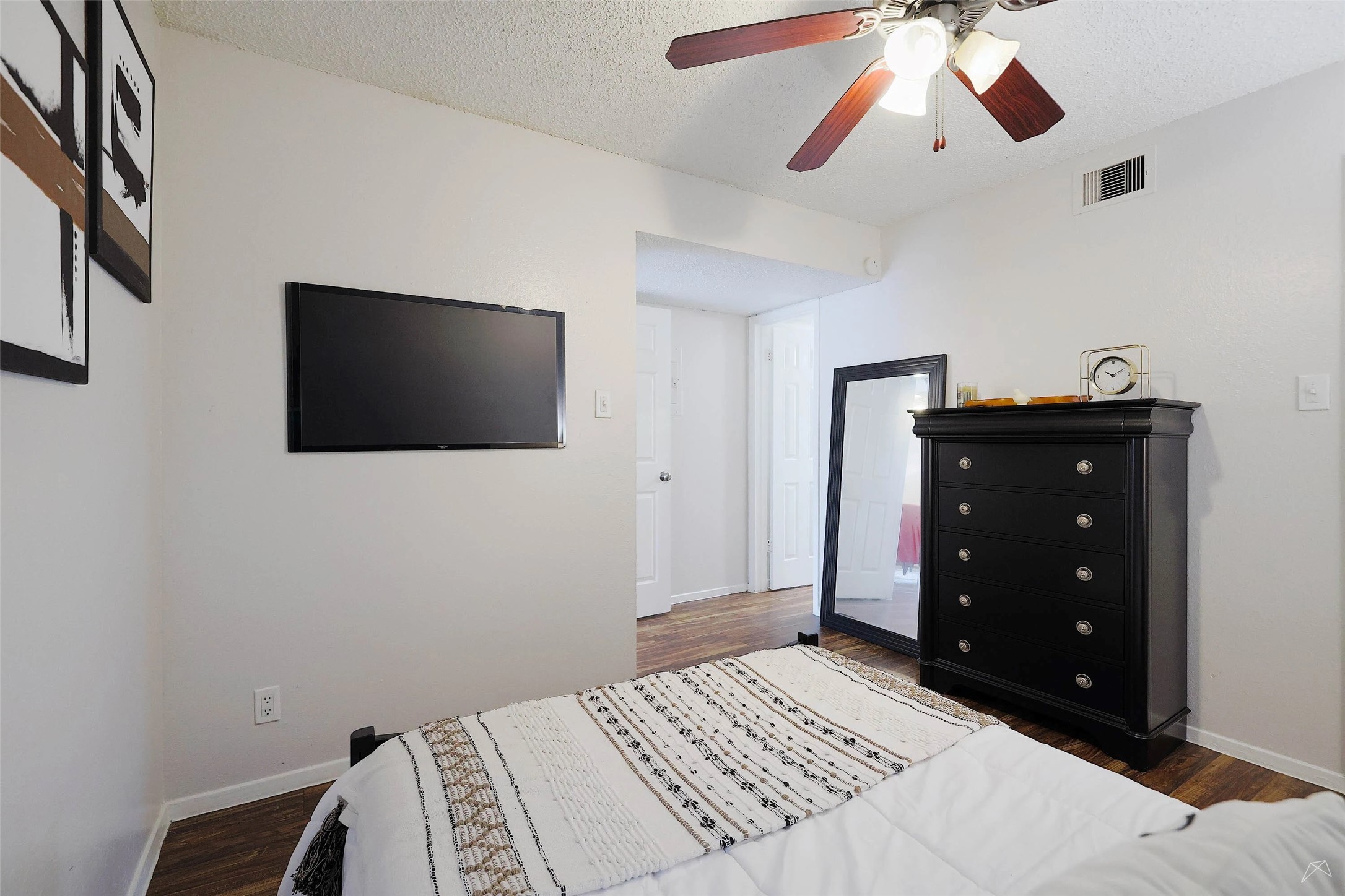6808 South I-35 Frontage Road, Unit 111 Austin, TX 78745 - Photo 5 of 22 a bedroom with a bed and a flat screen tv